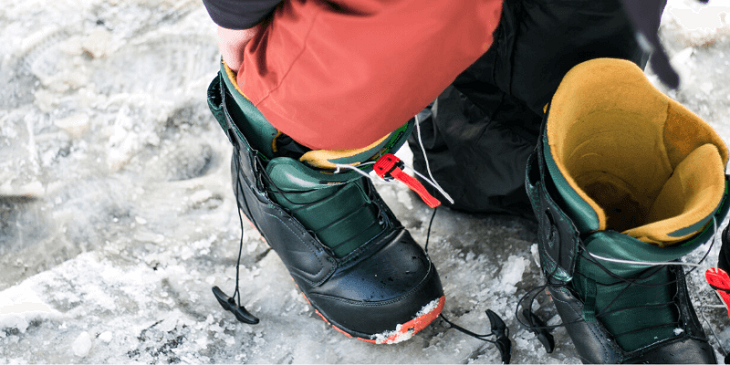 putting on snowboard gear for men 